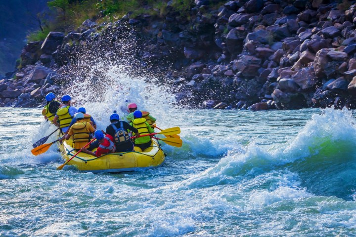 a group of people on a raft in the water