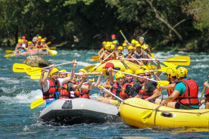 a group of people riding on the back of a boat