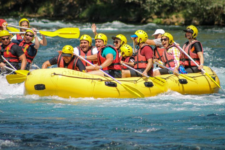 a group of people on a raft in the water