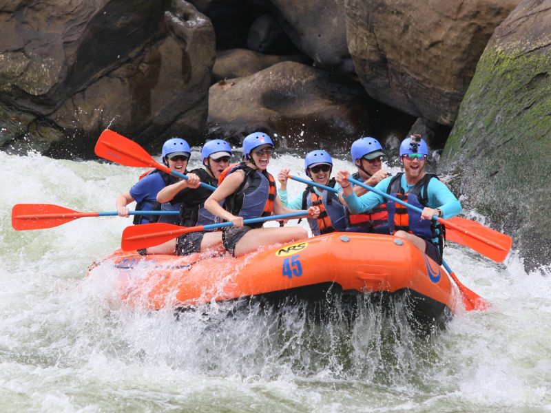 a group of people riding on a raft in the water