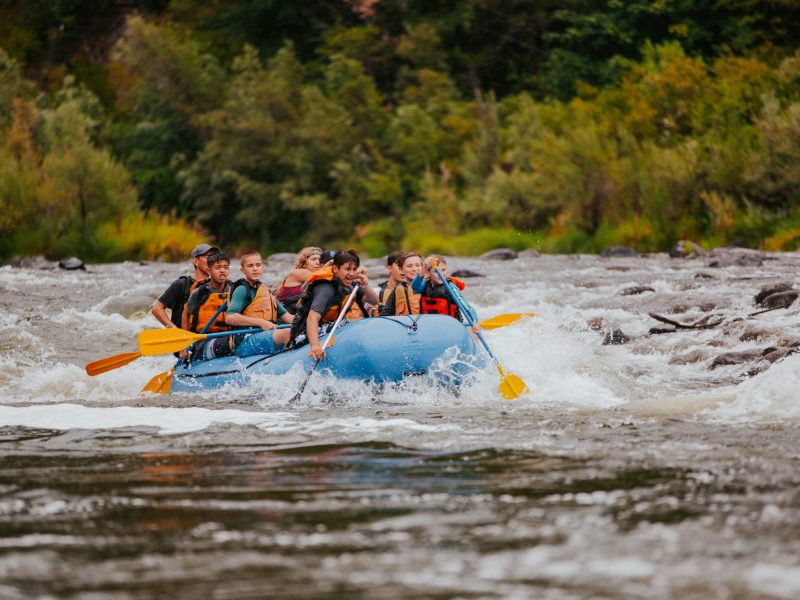 a man riding on a raft in a body of water