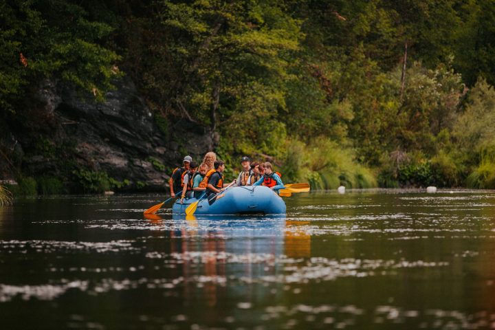 a group of people on a raft in a body of water