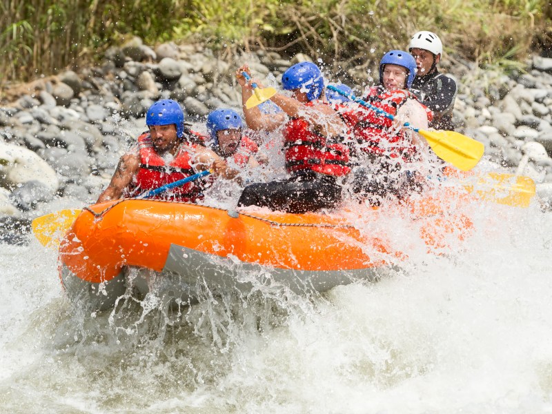a man riding a snow board in the water