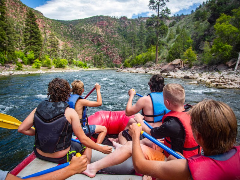 a group of people on a raft in a body of water